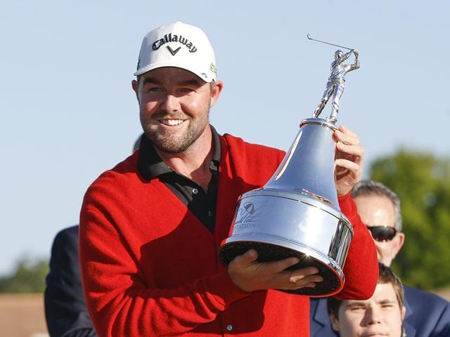 Winner, Marc Leishman, wearing the new traditional red cardigan  